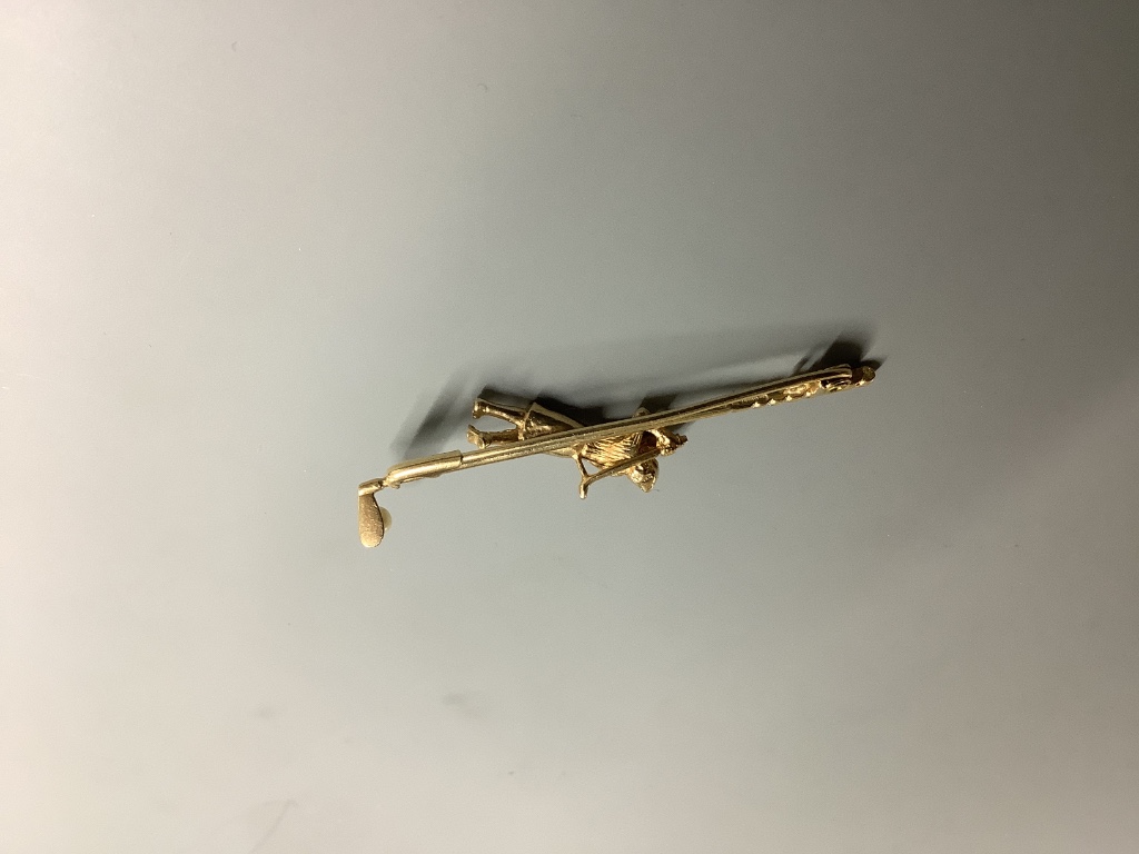 A modern 9ct gold and seed pearl set bar brooch, modelled as a golfer and golf club, 56mm, gross 4.8 grams.